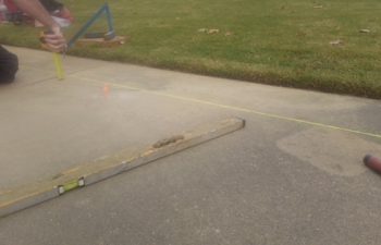 lifting the sidewalk for it to drain properly