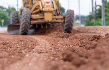 Red soil and heavy nachinery at a construction site.