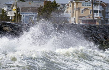 large storm waves crashing against the seawall